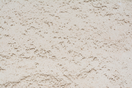 Texture of the surface of an old antique wall with a plaster layer destroyed from moisture, a lot of cracks, irregularities, blisters on the wall, abstract backgroundの写真素材