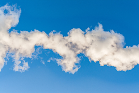 thick white smoke on a background of blue sky, abstract backgroundの写真素材