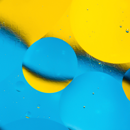 mixing water and oil, beautiful color abstract background based on blue and yellow circles and ovals, macro abstractionの写真素材