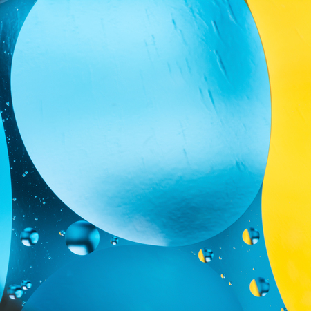 mixing water and oil, beautiful color abstract background based on blue and yellow circles and ovals, macro abstractionの写真素材