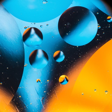 mixing water and oil, beautiful color abstract background based on blue and yellow circles and ovals, macro abstractionの写真素材