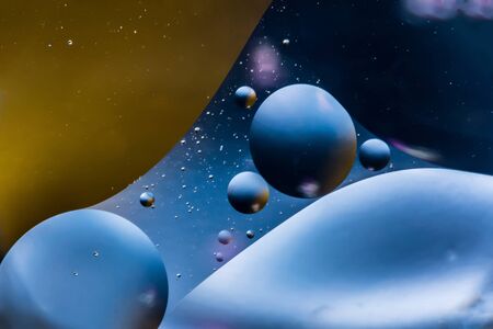 mixing water and oil, beautiful color abstract background based on blue and orange circles and ovals, macro abstractionの写真素材