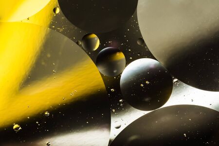 mixing water and oil, beautiful color abstract background based on white yellow and gray circles and ovals, macro abstractionの写真素材