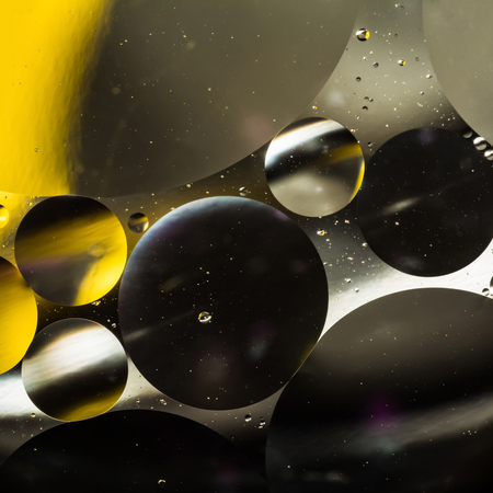 mixing water and oil, beautiful color abstract background based on white yellow and gray circles and...