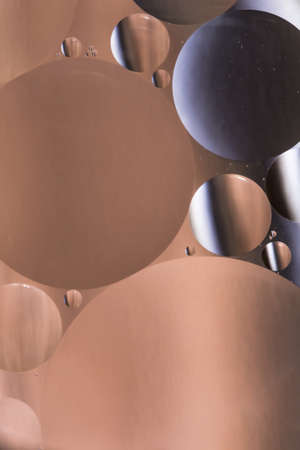 mixing water and oil, beautiful color abstract background based on brown and gray circles and ovals, macro abstractionの写真素材
