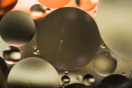 mixing water and oil, beautiful color abstract background based on brown and gray circles and ovals, macro abstractionの写真素材