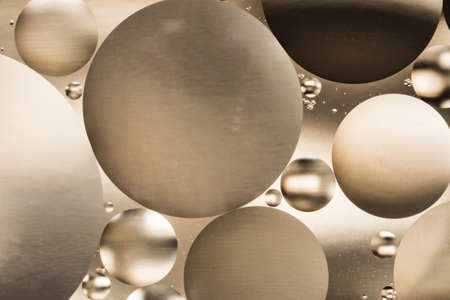 mixing water and oil, beautiful color abstract background based on brown and gray circles and ovals, macro abstractionの写真素材