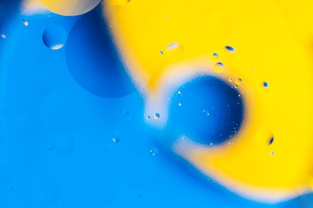 mixing water and oil, beautiful color abstract background based on yellow and blue circles and...