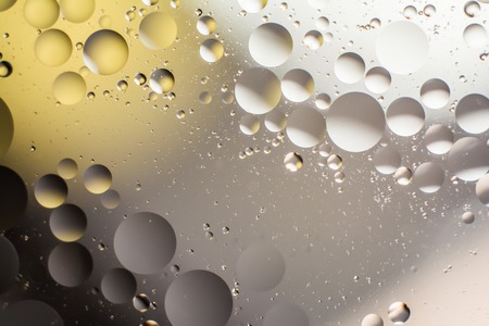 a combination of oil and water, a fantastic abstract macro background with blur elements and motion along the perimeter of the frameの写真素材