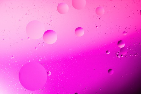 a combination of oil and water, a fantastic abstract macro background with blur elements and motion along the perimeter of the frameの写真素材