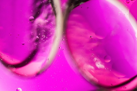 a combination of oil and water, a fantastic abstract macro background with blur elements and motion along the perimeter of the frameの写真素材
