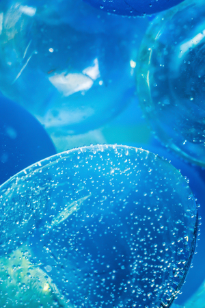 blue macro abstract background based on glass balls and bubbles in waterの写真素材