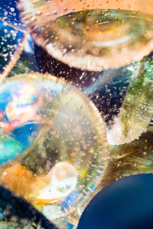 blue yellow macro abstract background based on glass balls and bubbles in waterの写真素材