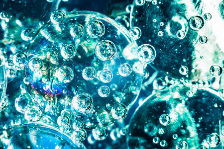 blurred blue macro abstract background based on glass balls and oxygen bubbles in water