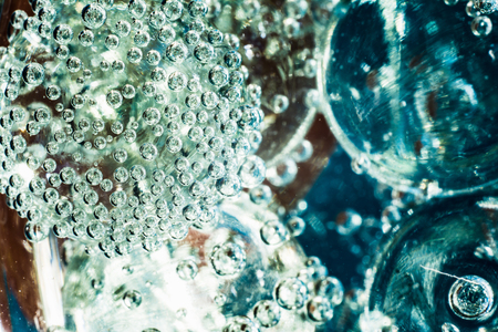 blurred macro abstract background based on glass balls and oxygen bubbles in waterの写真素材