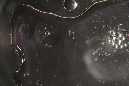 drops of water on the surface of the oil, variation of dissimilar liquids, macro art abstract backgroundの写真素材