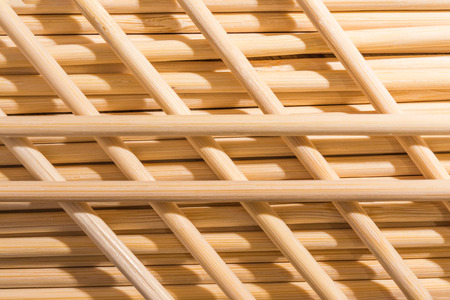 Round wooden sticks background. Wall Pattern. Close-up detail of round wooden sticks wall pattern,...