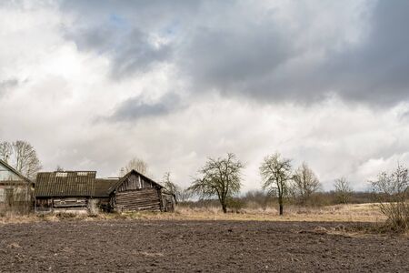 Old abandoned wooden rural buildings. Past time. Early spring times