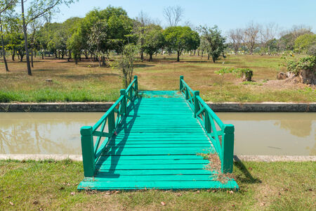 Green wood bridge in the gardenの写真素材