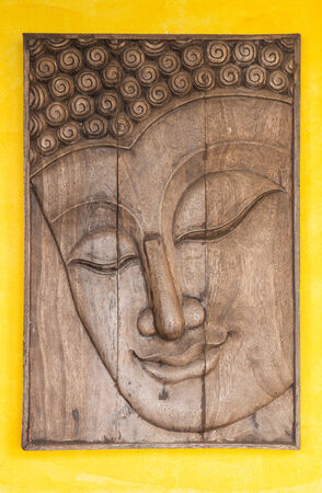 Face of a buddha wood handmade.Sculptures in the temple.の写真素材