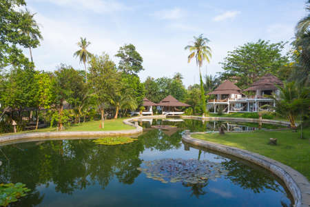 resort is next to the river surrounded by trees.の写真素材