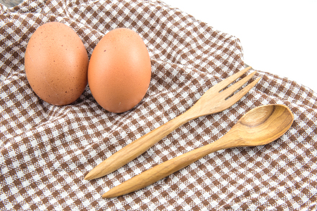 fresh eggs and spoon wooden on tableの写真素材