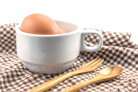 fresh eggs with cup and spoon wooden on tableの写真素材
