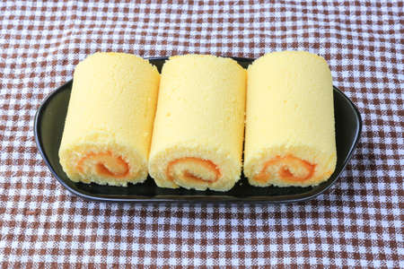 Orange roll cake on plateの写真素材