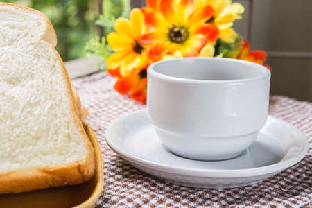 cup of coffee bread on tableの写真素材
