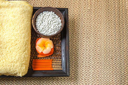 Spa and wellness setting with flowers, towel and Candle.の写真素材