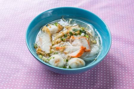 pork rice noodle soup from a bowl on tableの写真素材