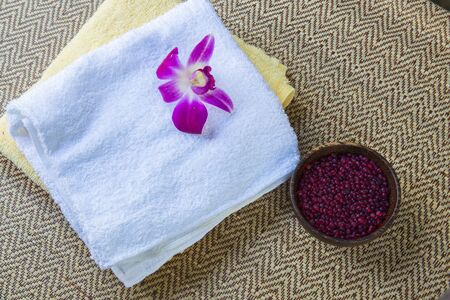 Spa and wellness setting with flowers and towelの写真素材