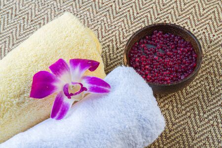 Spa and wellness setting with flowers and towelの写真素材