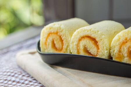 Orange roll cake on plateの写真素材