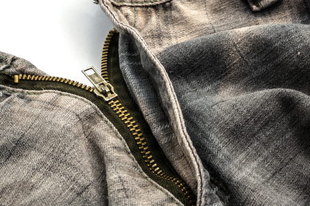 closeup of zipper on clothing backgroundの写真素材