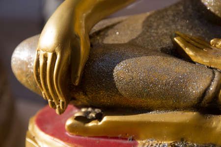 close up of the right hand of buddha statue in temple thailand, focus at handの写真素材