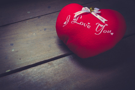 pillow red heart shaped on floor woodの写真素材