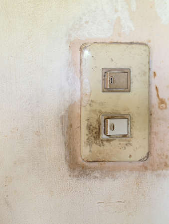 old light switch on the white wallの写真素材