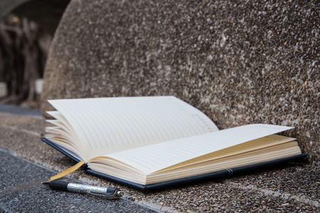Open a blank white notebook, pen with vintage filter