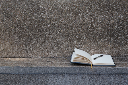 Open a blank white notebook, pen with vintage filterの写真素材