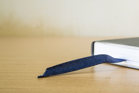 book with bookmark on wood tableの写真素材