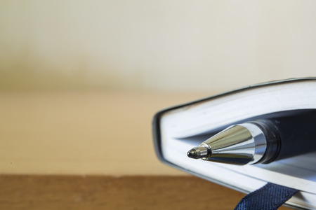 business or reading concept with notebook and penの写真素材