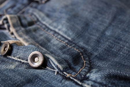 buttons on blue jeans. Nice for a background.の写真素材