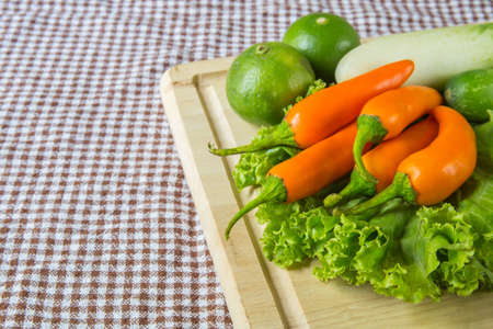 Fresh herbs and spices (chili, pepper, lettuce, lemon, cucumber)の写真素材