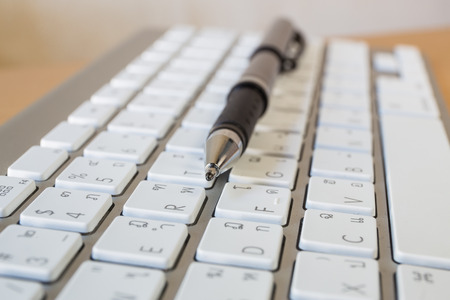 pen over laptop keyboard. Business concept, focus with penの写真素材