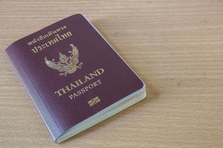 thailand passport on wood tableの写真素材