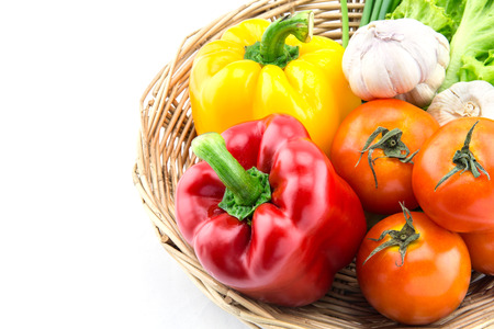 Organic vegetables in the wicker basket on white backgroundの写真素材