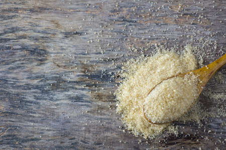 brown sugar heap and wooden spoonの写真素材