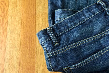 Blue jeans on old wooden surfaceの写真素材