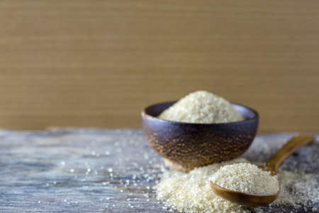 brown sugar heap and wooden spoonの写真素材